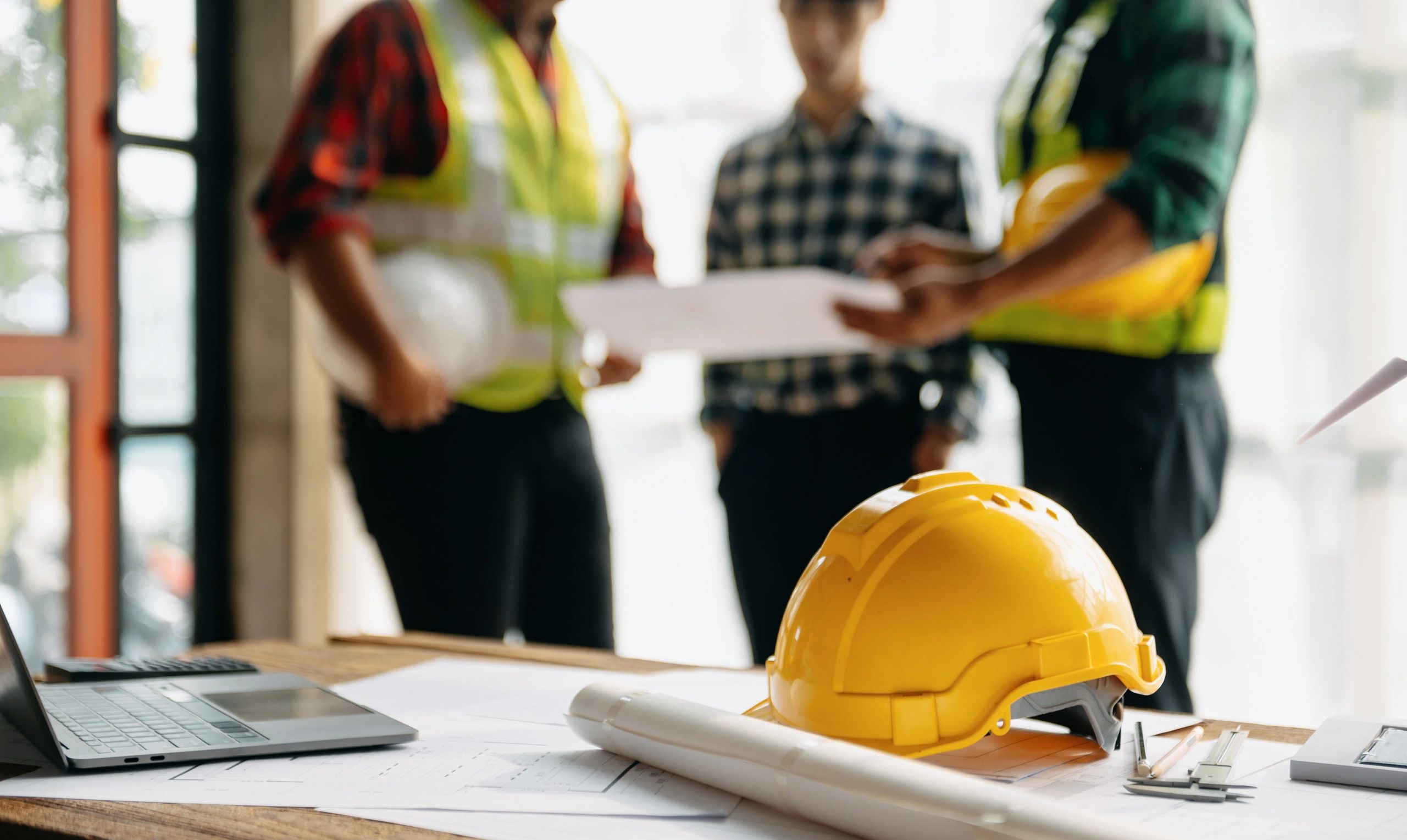 Construction site manager reviewing blueprints